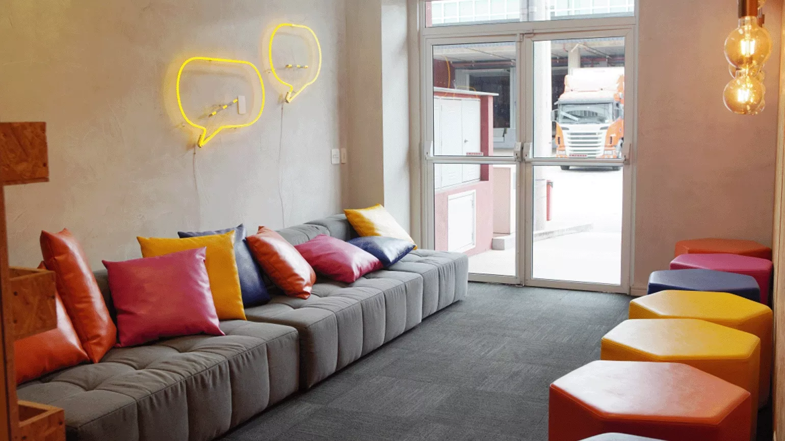 A room with a couch and chairs