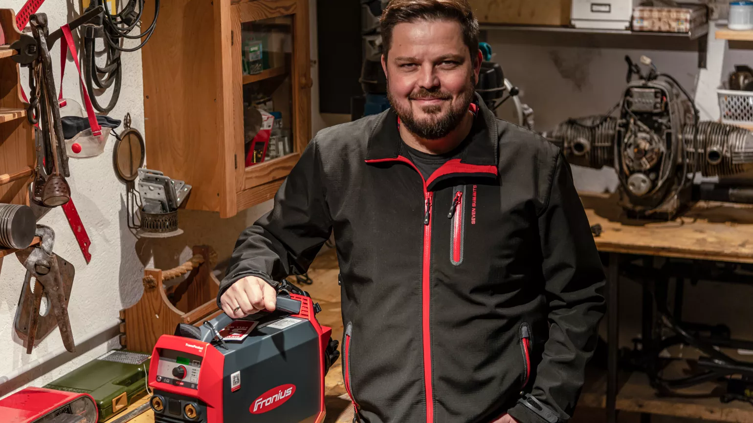 Welder proudly presents his welding machine