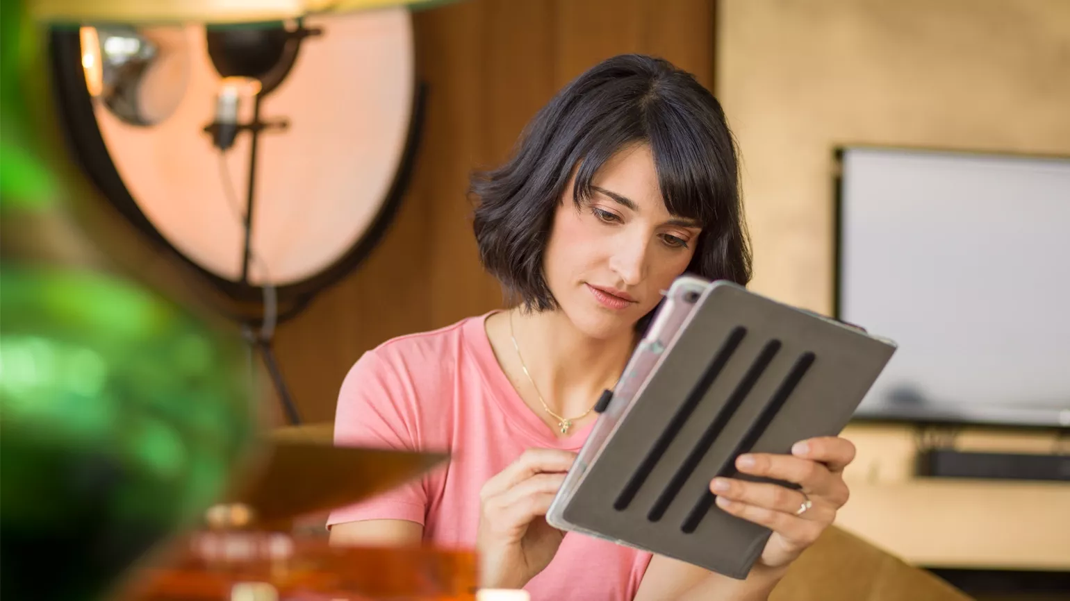 Woman monitoring on tablet in the living room
