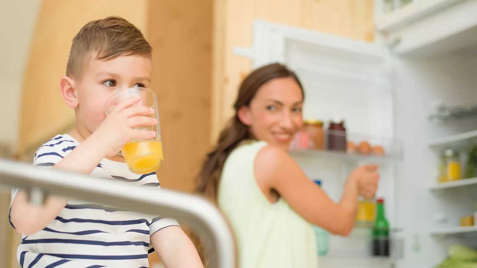 mother and kid in front of fridge