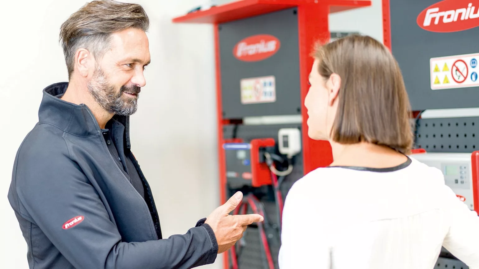 Consulting in front of  a Fronius charging module.
