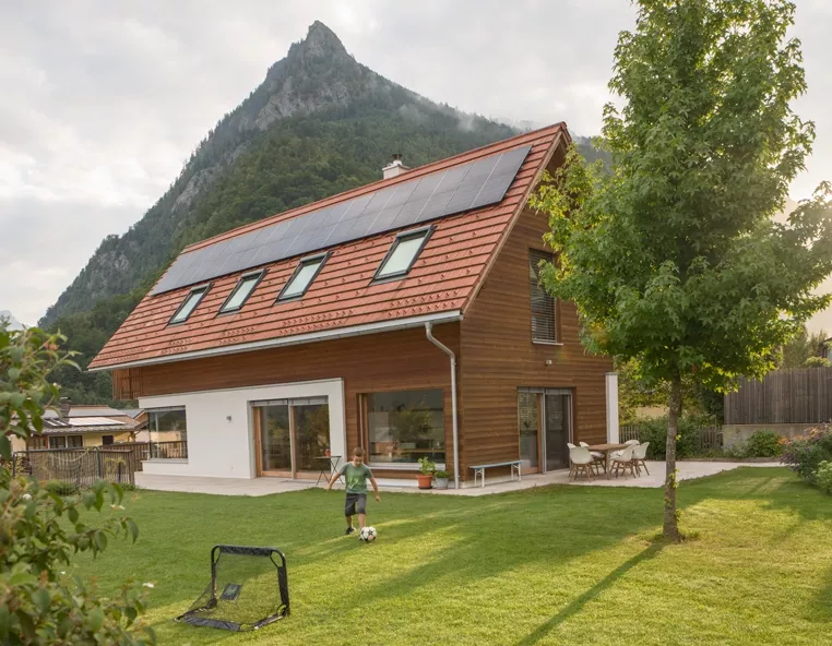 Boy in front of house with solar panels
