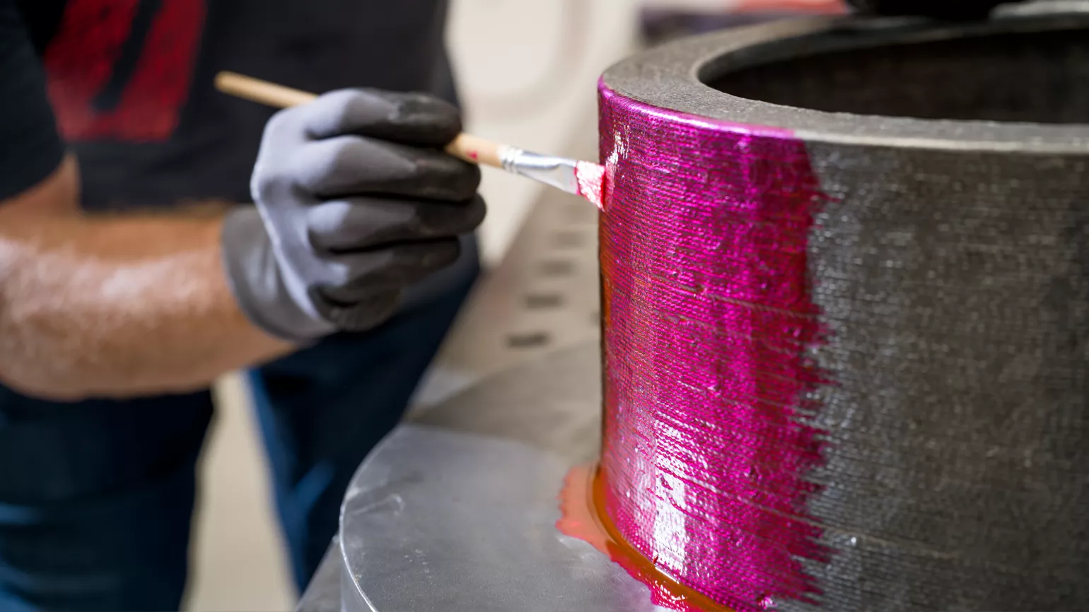 Man coating welding piece with testing liquid