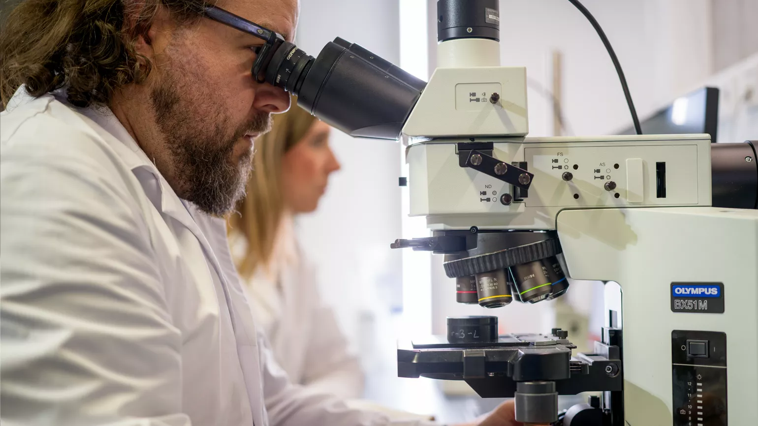 Scientist using microscope