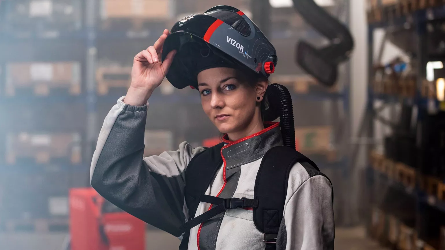 Female welder with helmet