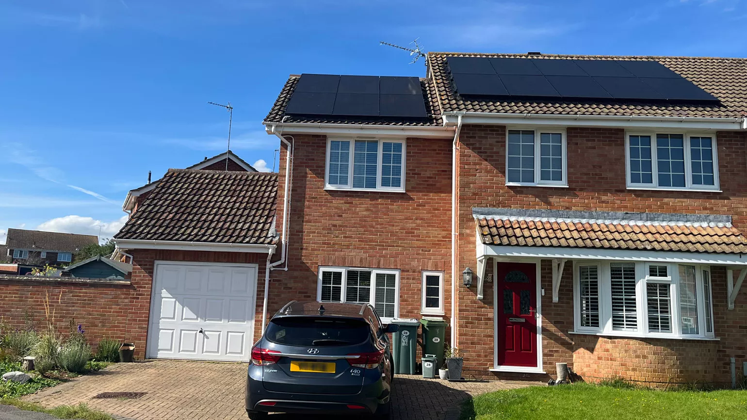 Outside of UK family home with panels on the roof