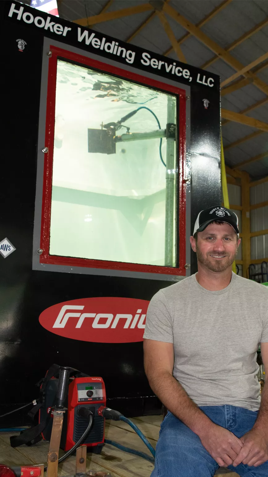 Kirk Hooker poses with his demo dive tank