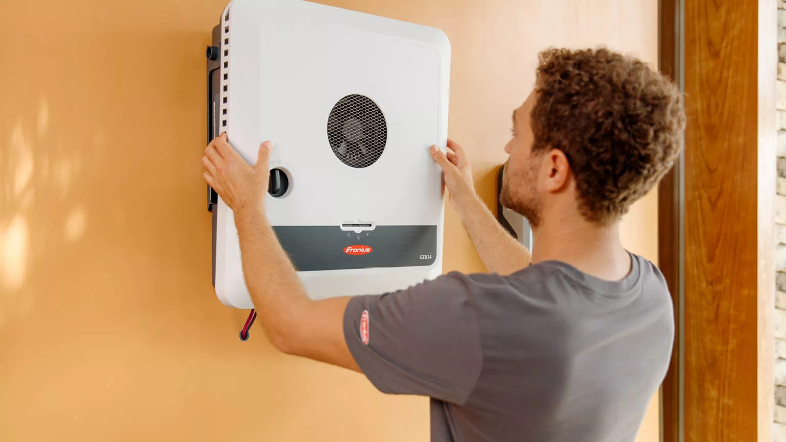 Man installing a Fronius inverter